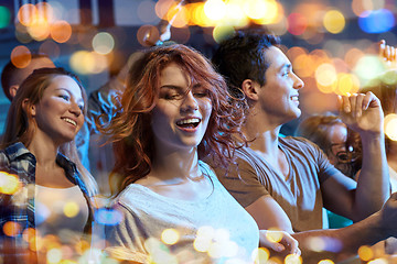 Image showing happy friends dancing at night club