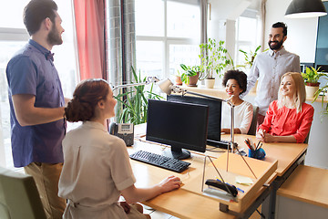 Image showing happy creative team talking in office