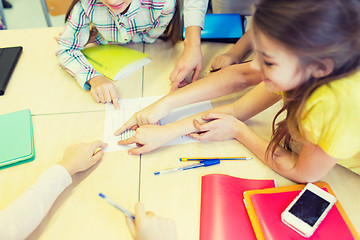 Image showing group of school kids pointing fingers to test