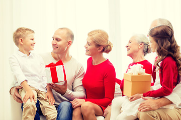 Image showing smiling family with gifts at home