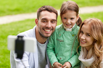 Image showing happy family taking selfie by smartphone outdoors