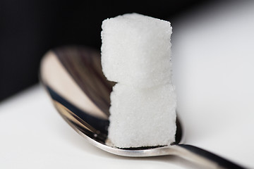 Image showing close up of white sugar cubes on teaspoon