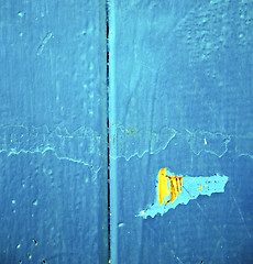 Image showing dirty stripped paint in the blue wood door and rusty nail