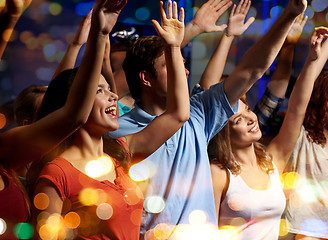 Image showing smiling friends at concert in club