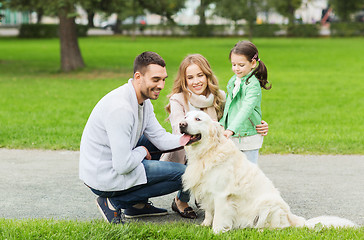 Image showing happy family with labrador retriever dog in park