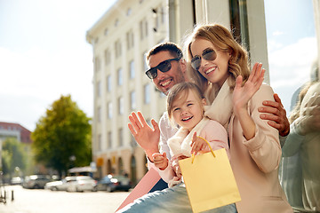 Image showing happy family with child and shopping bags in city