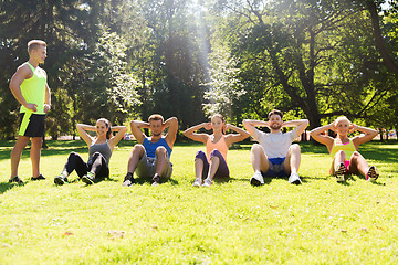 Image showing group of friends or sportsmen exercising outdoors