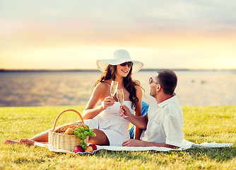 Image showing happy couple drinking champagne on picnic