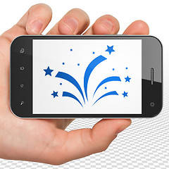 Image showing Entertainment, concept: Hand Holding Smartphone with Fireworks on display