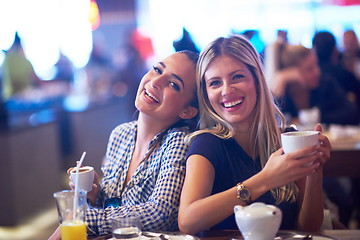 Image showing girls have cup of coffee in restaurant