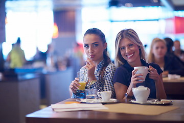 Image showing girls have cup of coffee in restaurant