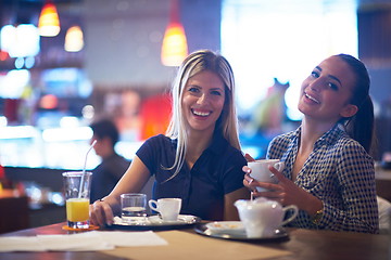 Image showing girls have cup of coffee in restaurant