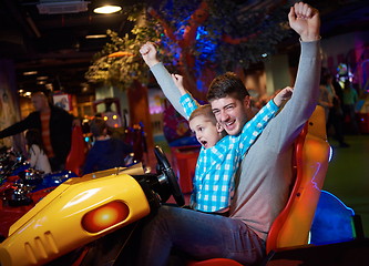 Image showing father and son playing game in playground