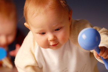 Image showing Baby playing with a toy