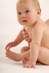 Image showing A baby looking around