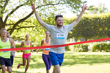 Image showing happy young male runner winning on race finish