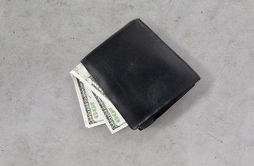 Image showing close up of dollar money in black wallet on table