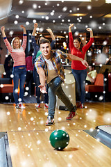 Image showing happy young man throwing ball in bowling club