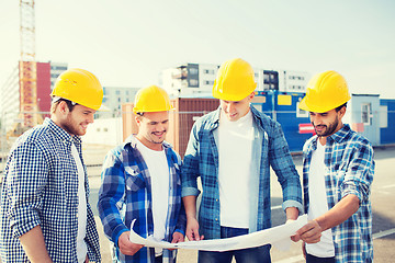 Image showing group of builders with tablet pc and blueprint