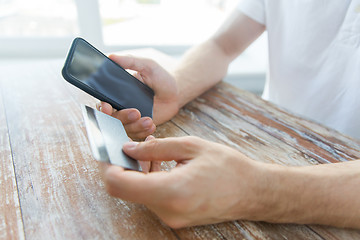 Image showing close up of hands with smart phone and credit card