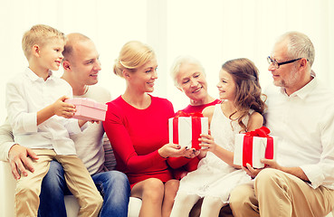 Image showing smiling family with gifts at home