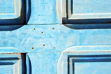 Image showing dirty   in   blue wood door and rusty nail