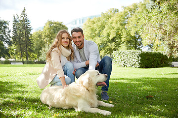 Image showing happy couple with labrador dog walking in city