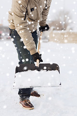 Image showing closeup of man digging snow with shovel