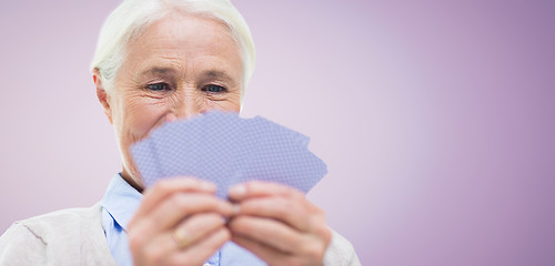 Image showing close up of happy senior woman playing cards