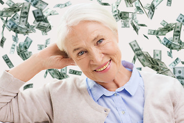 Image showing happy senior woman face over violet background