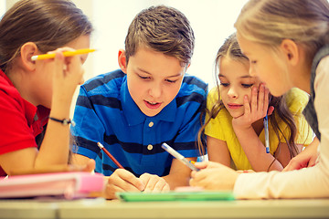 Image showing group of students talking and writing at school