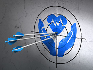 Image showing Insurance concept: arrows in Heart And Palm target on wall background