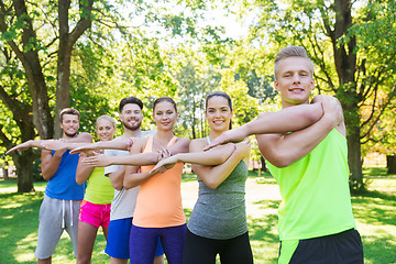 Image showing group of friends or sportsmen exercising outdoors