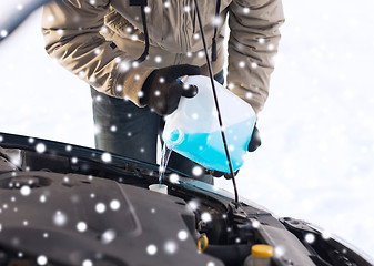 Image showing closeup of man pouring antifreeze into car