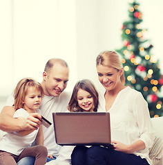 Image showing happy family with laptop computer