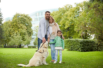 Image showing happy family with labrador retriever dog in park