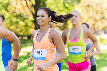 Image showing happy young sportsmen racing wit badge numbers