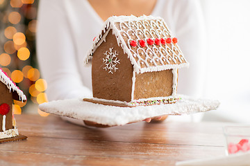 Image showing close up of woman showing gingerbread house