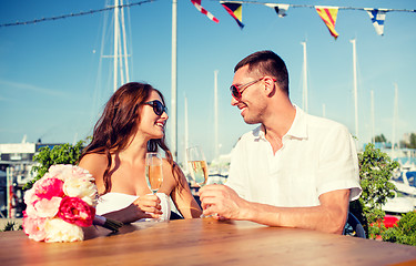 Image showing smiling couple drinking champagne at cafe