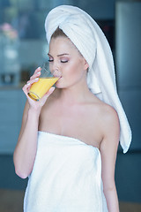 Image showing Woman in towel drinking juice