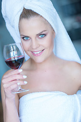 Image showing Woman in White Bath Towel Holding Glass of Wine