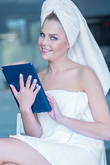 Image showing Woman in Bath Towel Holding Tablet Computer