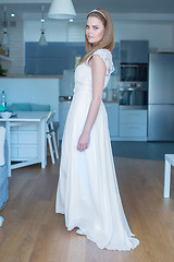 Image showing Woman Wearing Wedding Dress Standing in Kitchen
