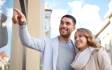 Image showing happy couple shopping and looking at shop window