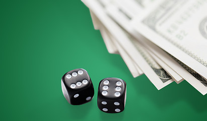 Image showing close up of black dice and dollar cash money