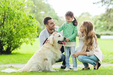 Image showing happy family with labrador retriever dog in park