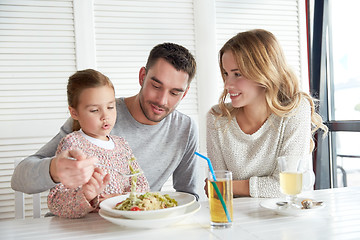 Image showing happy family having dinner at restaurant or cafe