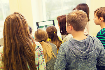 Image showing group of kids with teacher and computer at school