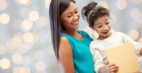 Image showing happy mother and child with gift box