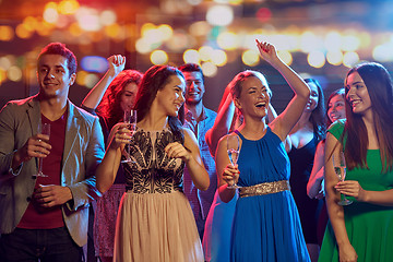 Image showing happy friends with champagne dancing at nightclub